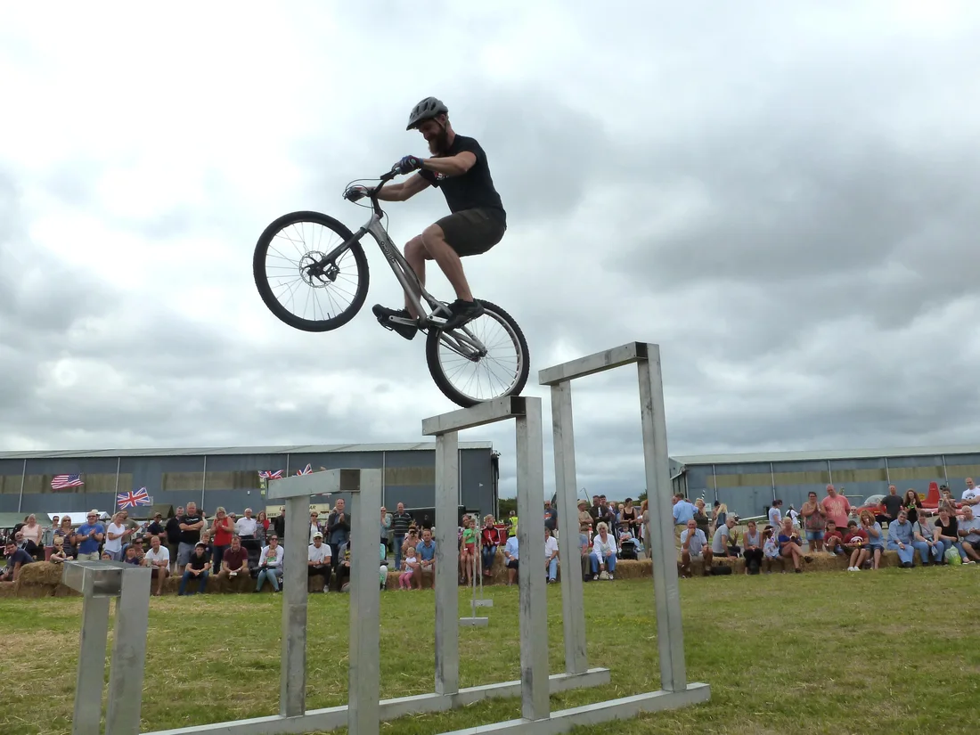 3SIXTY rider mid-air above a tall stunt obstacle
